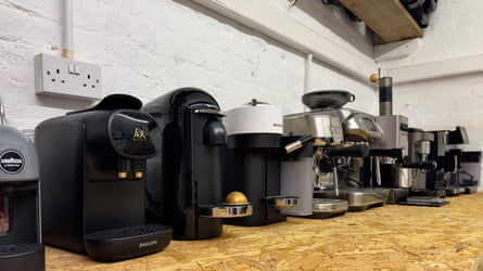 A row of nine coffee machines on a sideboard