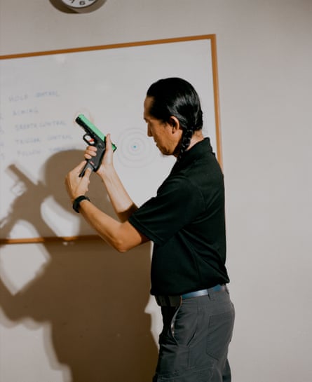 Tom Nguyen demonstrates how to load a gun. Before entering a shooting range, Nguyen holds a gruelling safety class for all his students.