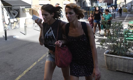 People flee from the scene after a white van jumped the sidewalk in the historic Las Ramblas district of Barcelona, Spain, crashing into a summer crowd of residents and tourists Thursday, Aug. 17, 2017. According to witnesses the white van swerved from side to side as it plowed into tourists and residents. (AP Photo/Giannis Papanikos)