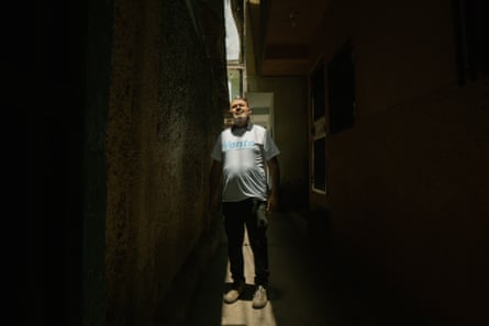 Oswaldo Rodríguez stands beneath a sliver of sunlight in a darkened alley