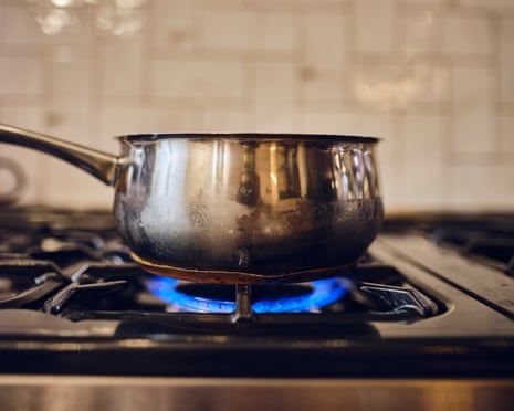 A gas ring burns on a home stove.