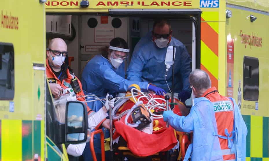 Medical staff transfer a patient from an ambulance to the Royal London hospital. 