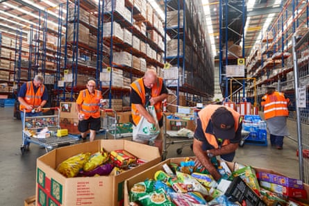 Volunteers organise large donations of goods at the Foodbank distribution centre in Sydney.