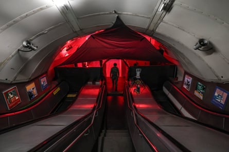 The entrance lit in red with a person standing at the centre