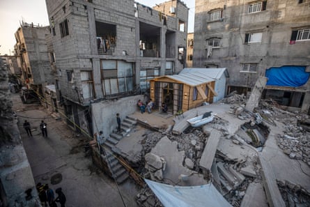 A temporary shelter built on top of the ruins of a destroyed home