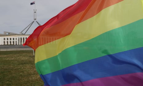 Parliament House with a rainbow flag out the front