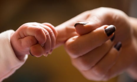 A baby holding its mother’s finger. What’s it really like having your first baby? We’d like new parents to tell us. 