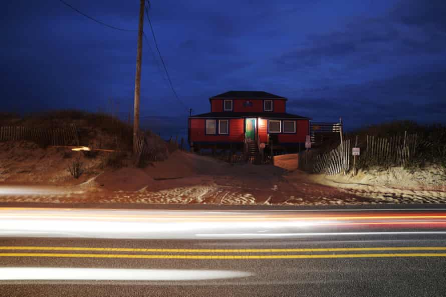 A driveway of sand in Kitty Hawk, North Carolina, leads to a beach house next to Highway 12.