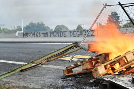 Graffiti reading ‘Macron and your world, get lost!’ is seen as protesters block the Cadix viaduct during a demonstration as part of the ‘block everything’ protest movement, near Caen, north-western France.