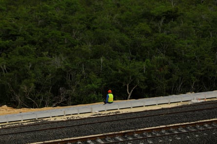 A worker rests during the construction of a section of the Maya Train in Cancún.