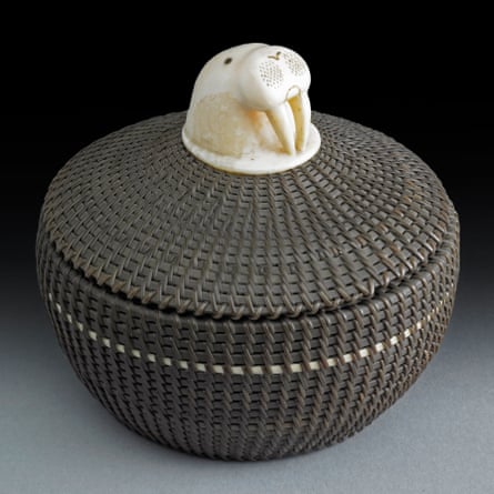 A round, coiled basket with carved decoration on the lid in the form of a walrus head with tusks by Marvin Peter, Alaska, 1952.