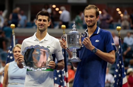 Daniil Medvedev and Novak Djokovic hold their trophies after the 2021 US Open final.