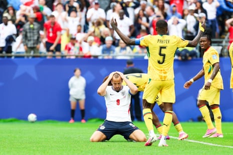Harry Kane on his knees on pitch with his hands on his head