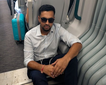 Akshay Vaghela sits on the floor of a crowded train