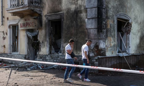 Ukrainian law enforcement officers inspect the missile strike site in Chernihiv