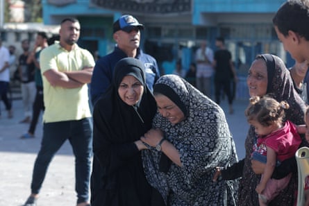 Palestinians mourn as the civil defence teams and civilians carry out search and rescue operations from the rubble after an Israeli attack on Nuseirat Refugee Camp.