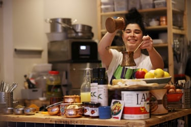 A smiling woman in a kitchen