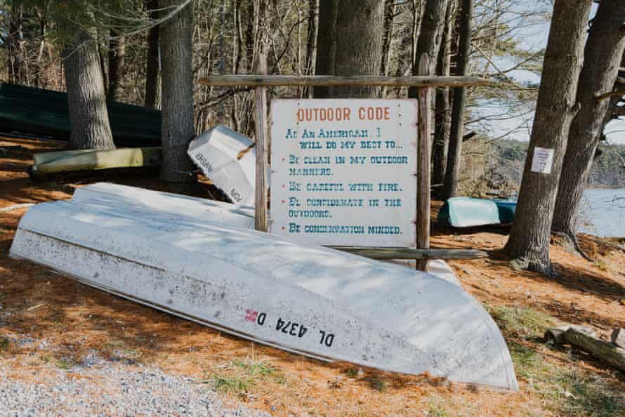 Recreational boats and a sign for the ‘outdoor code’ are seen at the shoreline of the Octoraro reservoir.