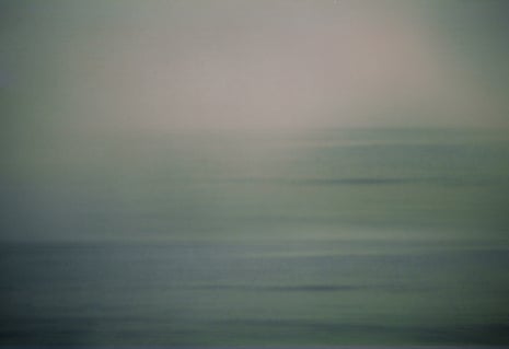 it is grey and merges with the sky as blurred horizontal lines shimmer in the light.