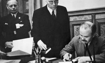 Soviet foreign minister Vyacheslav Mikhailovich Molotov signs the Soviet-German Non-Aggression Pact in Moscow, with German foreign minister Joachim von Ribbentrop looking on, 23 August 1939.