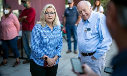 Dick Cheney and Liz Cheney standing on the street outside the library