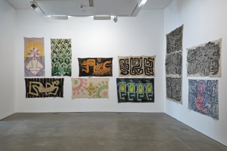 A gallery wall with 12 abstract figurative paintings