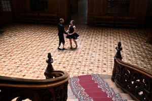 Couple dancing in hall in distance