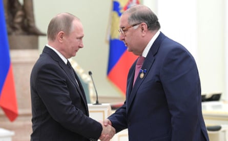 Vladimir Putin presents Alisher Usmanov, the founder of USM Holdings group, the decoration For Beneficence during a ceremony at the Kremlin in Moscow in January 2017.