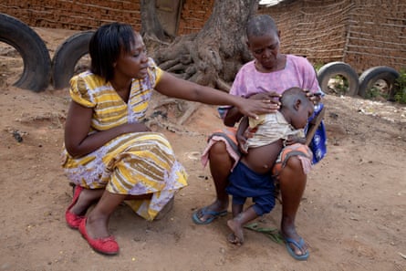 Phyllis Omido talking with a woman whose grandson is suffering from lead poisoning, in Owino Uhuru, Kenya.
