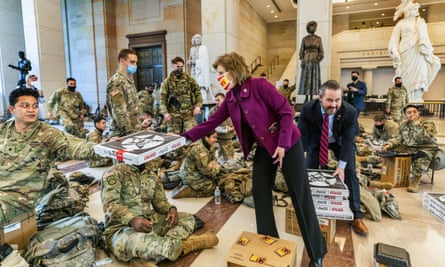 Republicans Vicky Hartzler and Michael Waltz hand pizzas to members of the National Guard on Wednesday.