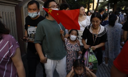 A child waves the Chinese national flag outside the US consulate in Chengdu in south-west China on Sunday.