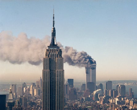 The twin towers of the World Trade Center burn behind the Empire State Building in New York.