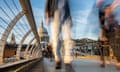 Rushing Commuters on the Millennium Bridge, London<br>Blurred commuters walking on the Millennium Bridge, and St Paul's Cathedral, London.