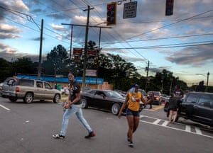 A protester paces with an Uzi submachine gun as demonstrators use vehicles to block a busy intersection in Atlanta, Georgia on 16 June 2020. This was days of the death of Rayshard Brooks