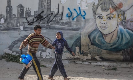Palestinian refugee boys play in the streets of a refugee camp in Gaza City this month.