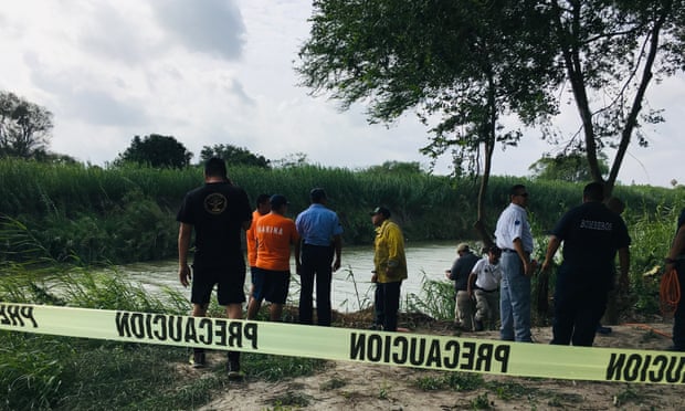 Authorities stand behind yellow warning tape along the Rio Grande bank where the bodies of Salvadoran migrant Oscar Alberto Martínez Ramírez and his daughter Valeria were found, in Matamoros, Mexico Monday.