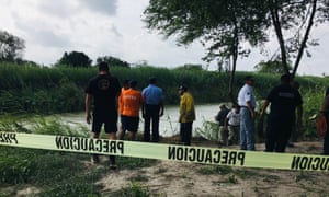 Authorities stand behind yellow warning tape along the Rio Grande where the bodies of Ãscar Alberto MartÃ­nez RamÃ­rez and his daughter Valeria were found, in Matamoros, Mexico, on Monday.