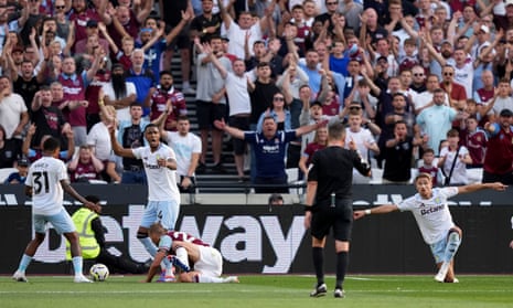 An action scene from the match, with Aston Villa players wearing shirts with the logo of Betano, and a pitchside billboard behind them saying 'Betway'