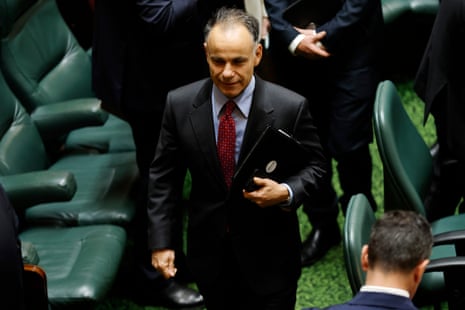 A man with short hair in a suit