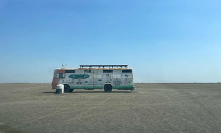 A bus covered in paintings of cartoon characters.