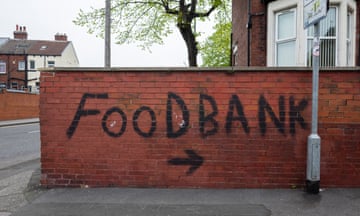 A brick wall with FOODBANK and an arrow covering it