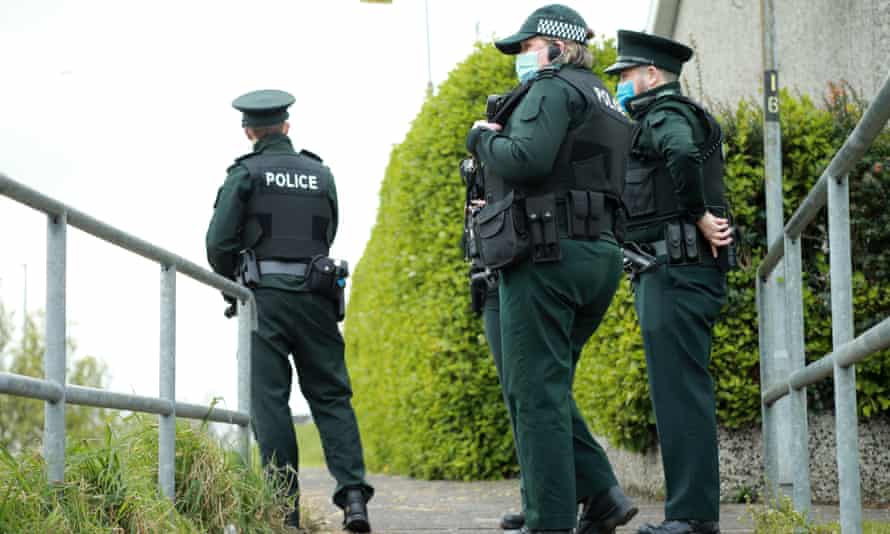 Three police officers patrol on foot