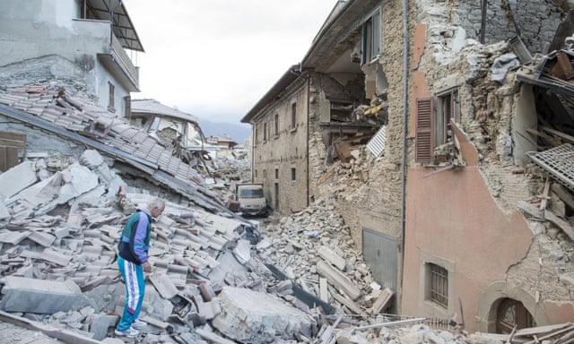 A man walks on the rubble of collapsed buildings in Amatrice, Italy, on Wednesday.