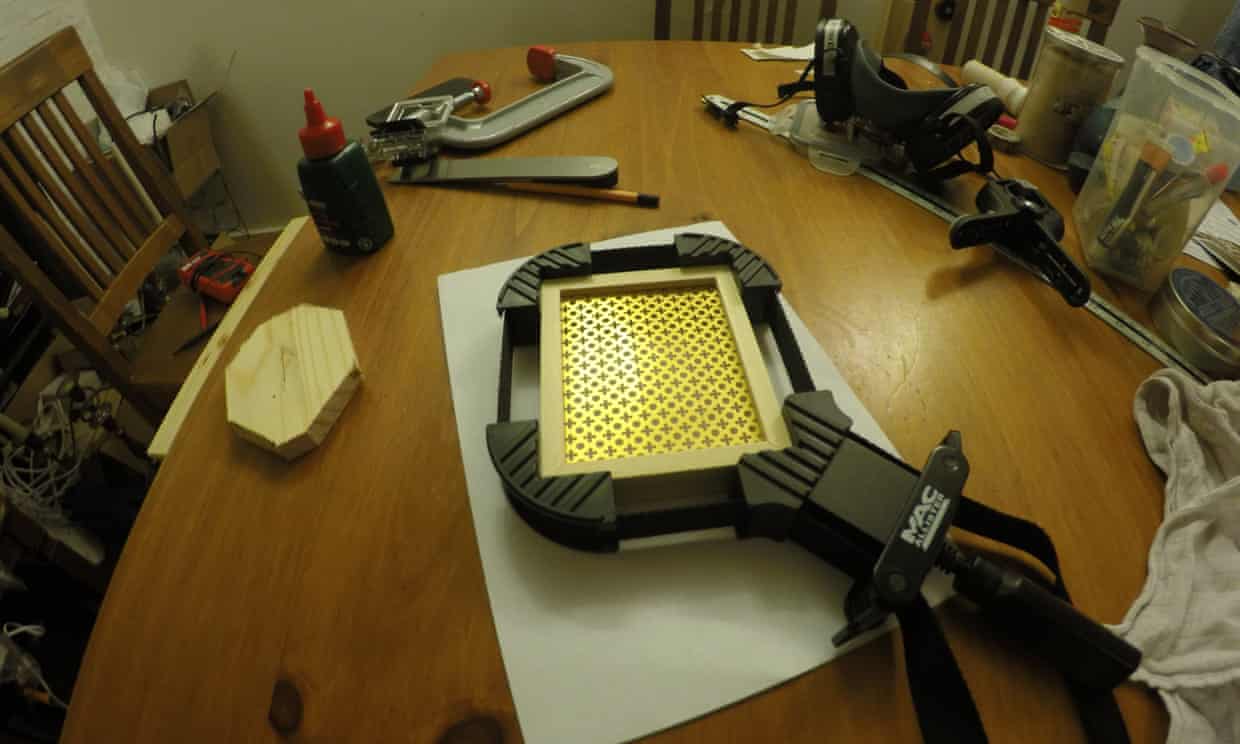 The short chimney for the power supply, held in a frame clamp while the glue sets.
