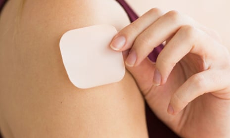 Woman applying a contraceptive patch.