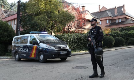 A Spanish police officer stands outside the Ukrainian embassy in Madrid after a bloody package was sent there