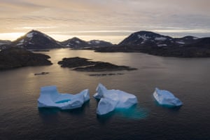 Large Icebergs float away as the sun rises near Kulusuk.