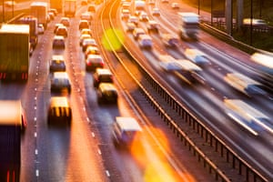 Manchester, UK: Rush hour traffic on the M60 motorway at sunset. Consumption of one gallon of petrol emits around 10.2kg of C02.