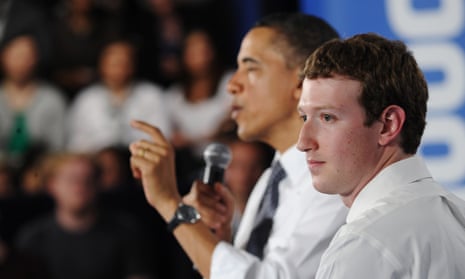 Mark Zuckerberg listens to Barack Obama speak during a town hall meeting in 2011.