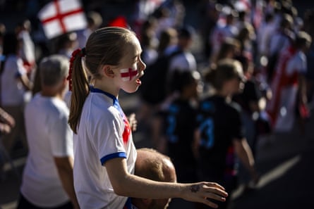 A young girl with an England flag painted on her face walks to the stadium for the Sweden v England semi-final
